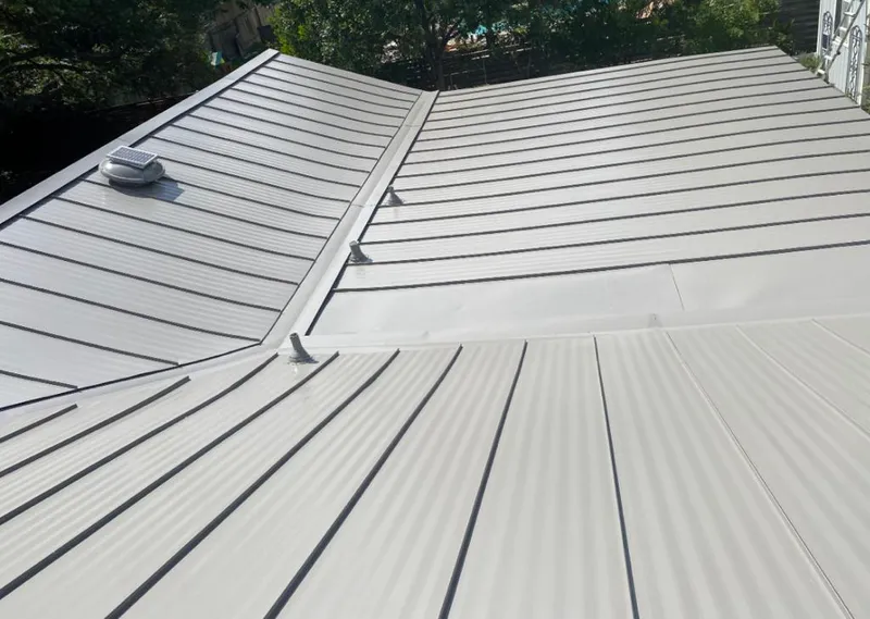 Solar attic fan installed on a metal roof for Roof Ventilation in Keyes